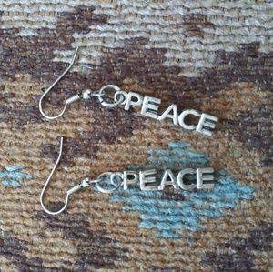 Never worn PEACE silver dangle earrings